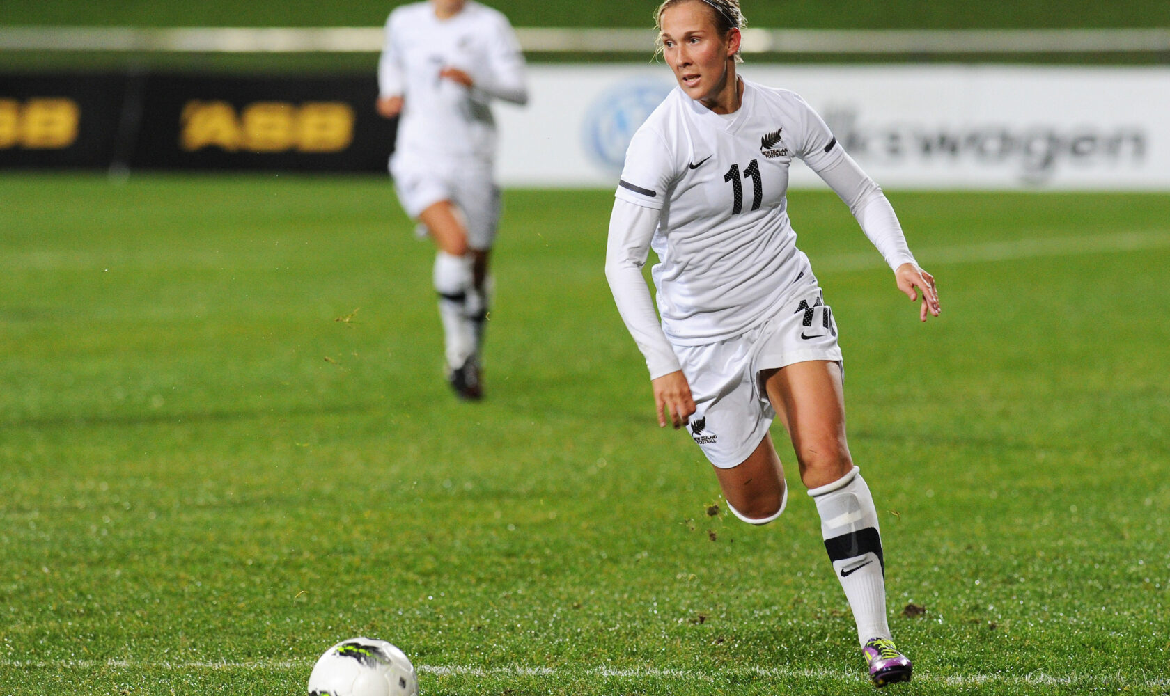 Kirsty Yallop running on football pitch