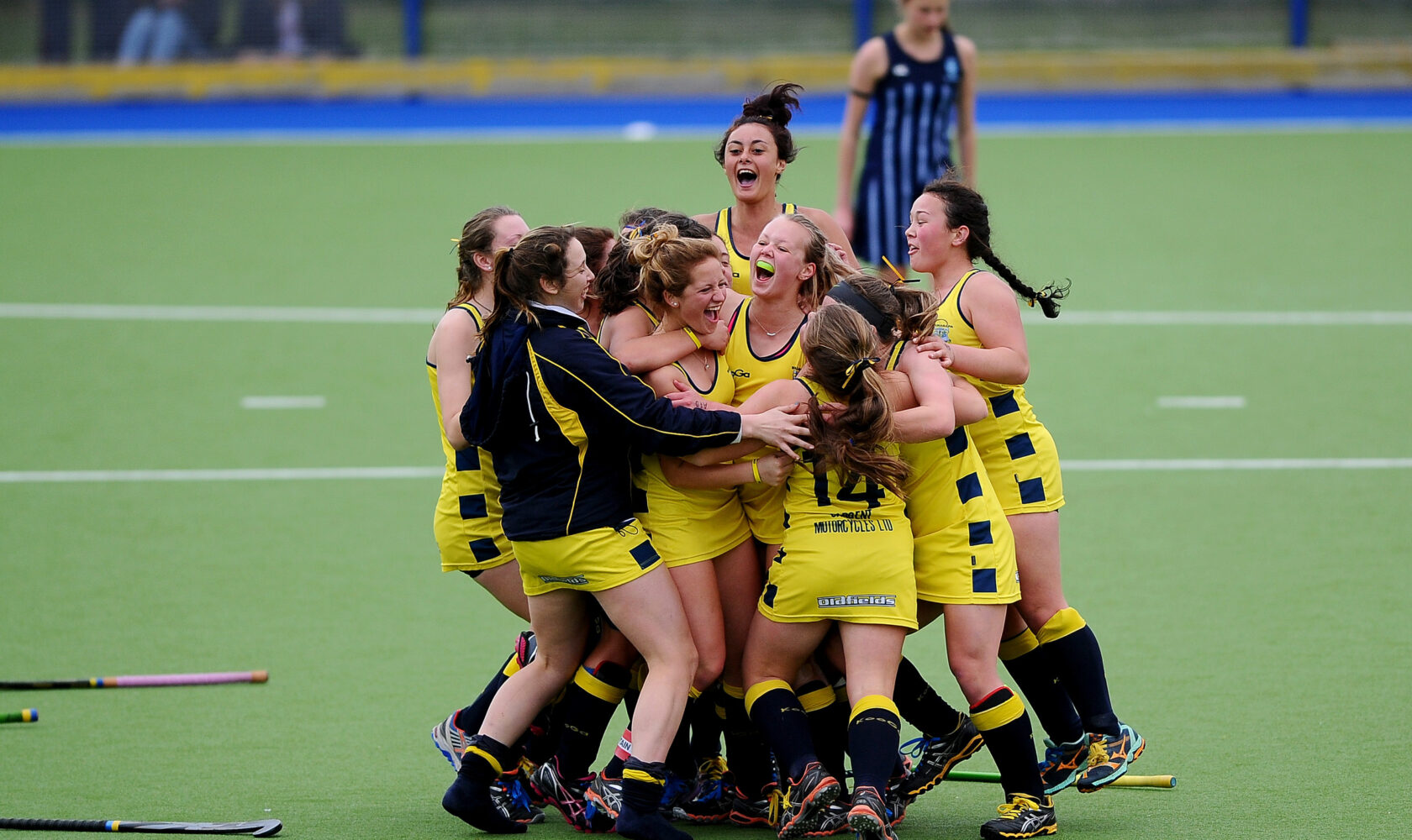 Young people celebrate on hockey pitch