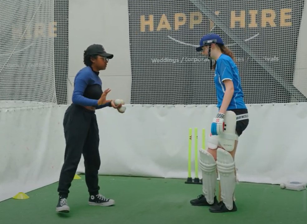 Cricket coach and participant in cricket net