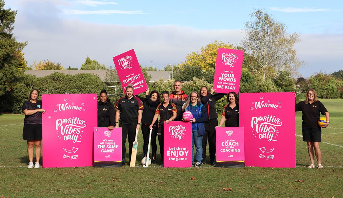 Group of people holding pink support signs.